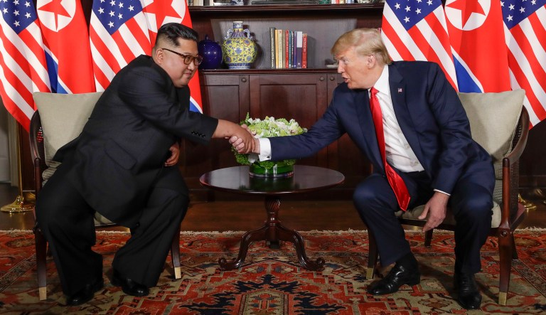North Korean leader Kim Jong Un, left, and President Trump shake hands during their first meeting at the Capella resort on Sentosa Island in Singapore on Tuesday.