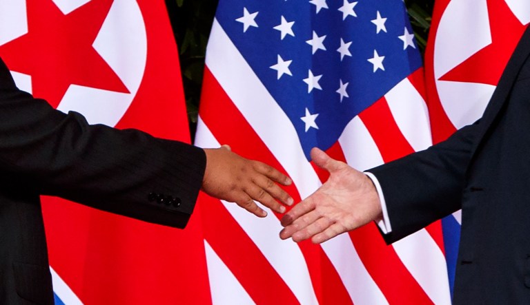 President Trump reaches to shake hands with North Korea leader Kim Jong Un at the Capella resort on Sentosa Island in Singapore on June 12, 2018.