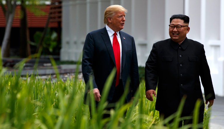 President Trump (left) walks with North Korean leader Kim Jong Un on Sentosa Island, Tuesday, in Singapore.