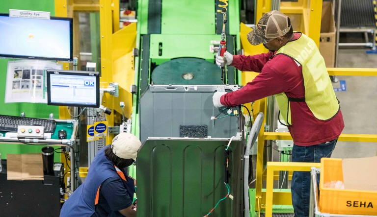 Workers build washing machines on the assembly line at the Samsung washing machine facility in Newberry, S.C.