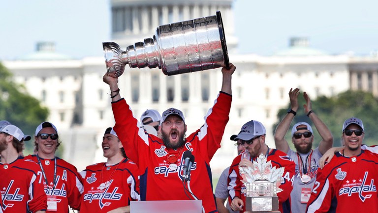 Washington Capitals' Alex Ovechkin, of Russia, holds up the Stanley Cup trophy during the NHL hockey team's Stanley Cup victory celebration at the National Mall in Washington.