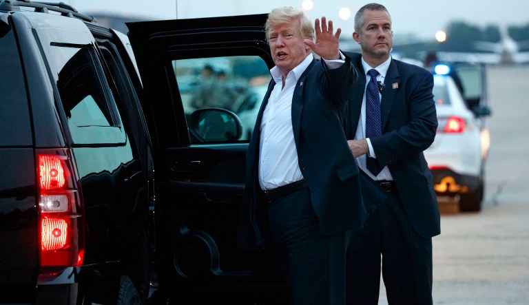 U.S. President Donald Trump yells to reporters after arriving at Andrews Air Force Base after a summit with North Korean leader Kim Jong Un in Singapore, Wednesday, June 13, 2018, in Andrews Air Force Base, Md.