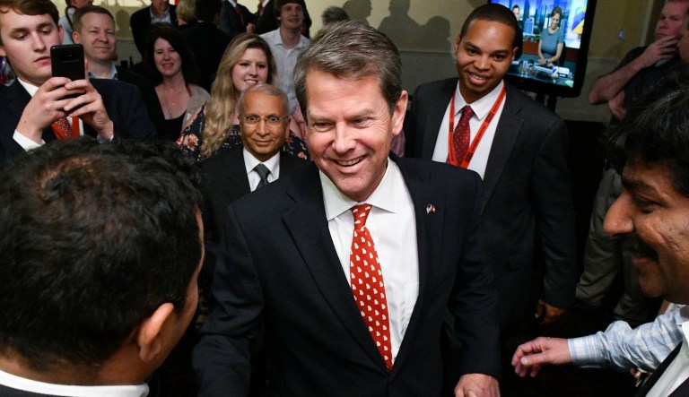 Georgia Secretary of State Brian Kemp, Republican primary candidate for governor, celebrates with supporters after giving a speech in Athens, Ga.
