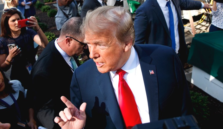 President Trump speaks to reporters on the North Lawn of the White House on Friday in Washington.