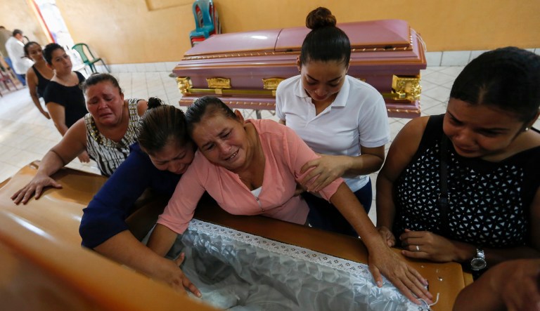 Friends and family mourn the body of 5-month-old Matias Velasquez after six members of the Velazquez family died in blaze after armed assailants set fire to their house in Managua, Nicaragua, on June 17, 2018.