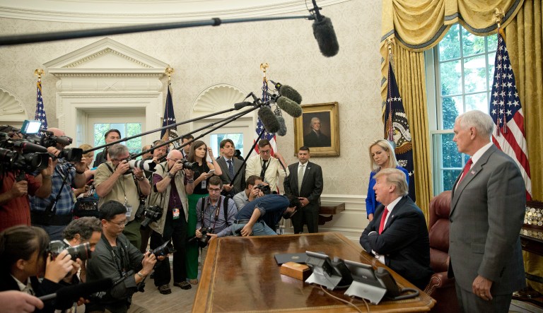 President Trump speaks to members of the media during an event in the Oval Office. 