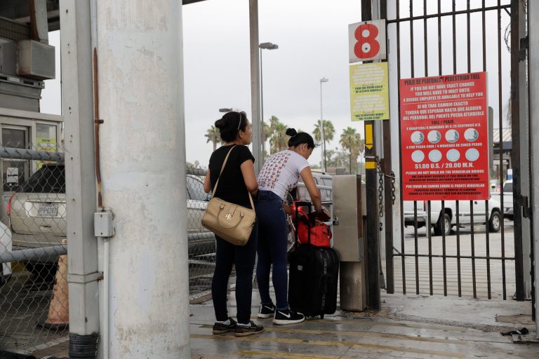Josseline Garcia, 20, and Jennifer Garcia, 24, sisters from Guatemala seeking asylum, cross a bridge to a port of entry in to the United States from Matamoros, Mexico, Wednesday, June 20, 2018, in Brownsville, Texas.