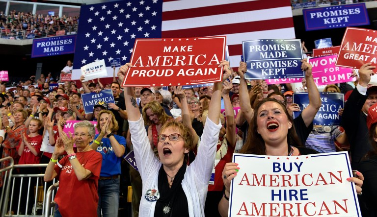 People cheer as President Donald Trump speaks at a rally at AMSOIL Arena in Duluth, Minn., Wednesday, June 20, 2018.