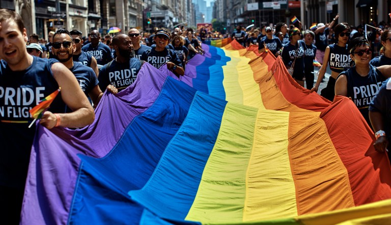 Reveler carry a LTBGQ flag along Fifth Avenue during the New York City Pride Parade on Sunday, June 24, 2018, in New York.