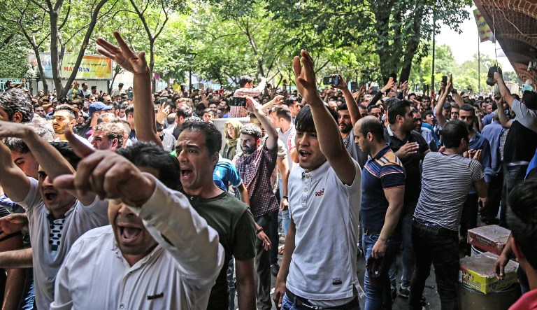 A group of protesters chant slogans at the old grand bazaar in Tehran, Iran, on Monday. Protesters in the Iranian capital swarmed its historic Grand Bazaar on Monday, news agencies reported, and forced shopkeepers to close their stalls in apparent anger over the Islamic republic's troubled economy, months after similar demonstrations rocked the country.