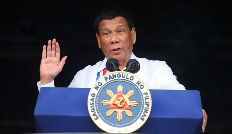 Philippine President Rodrigo Duterte gestures while addressing the crowd at the 120th Philippine Independence Day celebrations south of Manila, Philippines. President Duterte, notorious for having insulted the pope and former U.S. President Barack Obama, has sparked outrage for calling God "stupid" in Asia's bastion of Catholicism.
