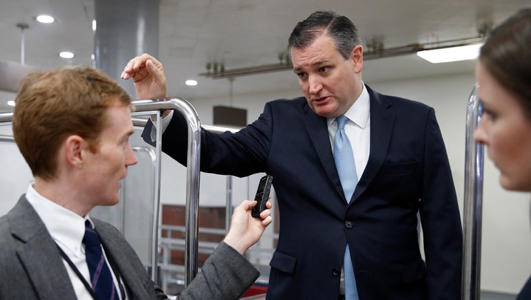 Sen. Ted Cruz, R-Texas, center, speaks to reporters as he boards the Senate subway.