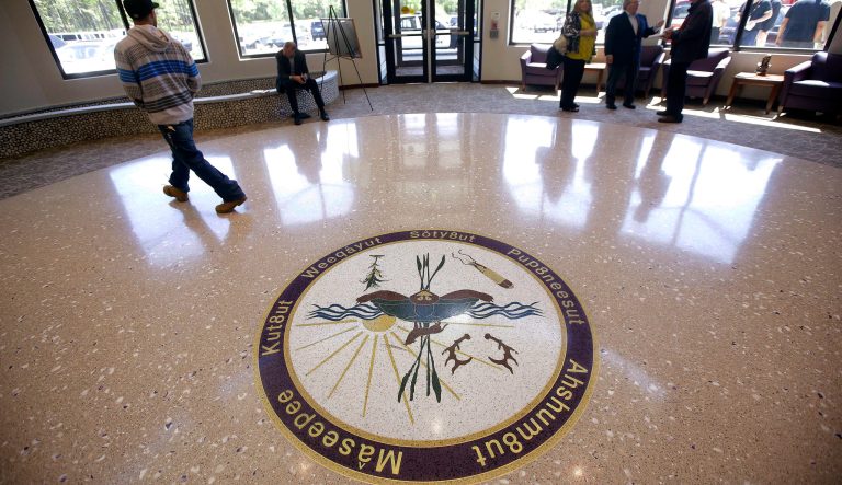 In this May 29, 2014 photo, people stand in the lobby of the Mashpee Wampanoag Tribe's Community Government Center in Mashpee, Mass., on Cape Cod. 