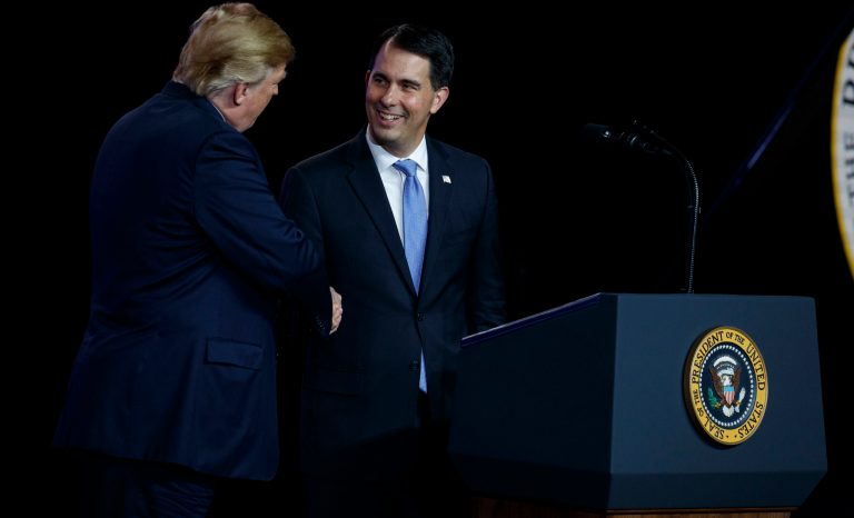 President Donald Trump shakes hands with Gov. Scott Walker, R-Wis., Thursday, June 28, 2018, in Mt. Pleasant, Wis. 