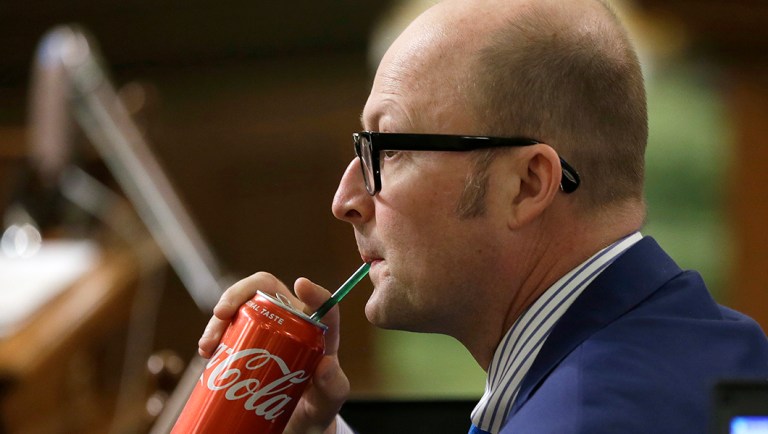 Assemblyman Matthew Harper, R-Huntington Beach, sips a Coke as Assembly members debate a ban on local soda taxes.