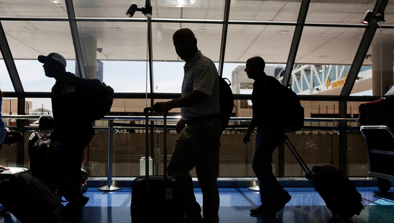 Travelers wait in lines to check their luggage and receive boarding passes at the Fort LauderdaleâHollywood International Airport.