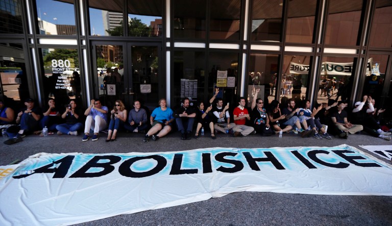 Protesters block the entrance to a downtown federal building housing Immigration and Customs Enforcement offices in San Diego.