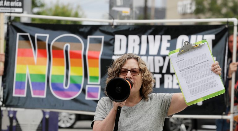 Margo Heights speaks into a megaphone during a protest against President Donald Trump's choice of federal appeals Judge Brett Kavanaugh as the president's second nominee to the Supreme Court, during a protest.