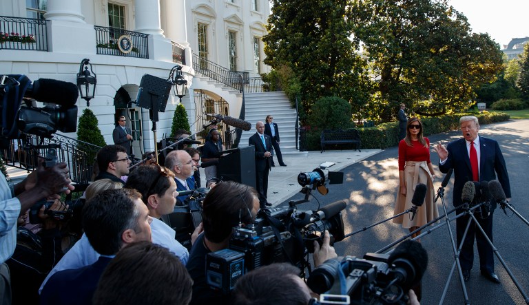 First lady Melania Trump looks on as President Trump speaks with reporters before boarding Marine One on the South Lawn of the White House, Tuesday, July 10, 2018, in Washington. 