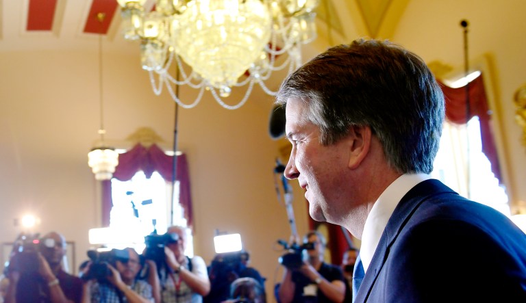 Supreme Court nominee Brett Kavanaugh, right, walks past the press following a photo opportunity on Capitol Hill in Washington on Tuesday.