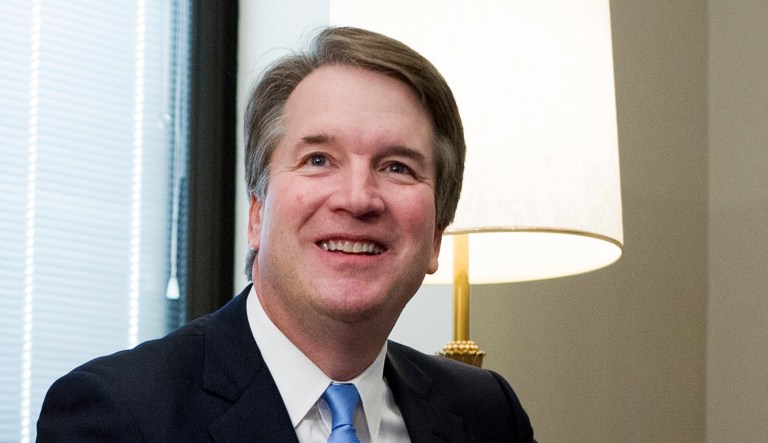 Supreme Court nominee Brett Kavanaugh sits on a couch before meeting with Sen. Dan Sullivan, R-Alaska, on Capitol Hill in Washington.