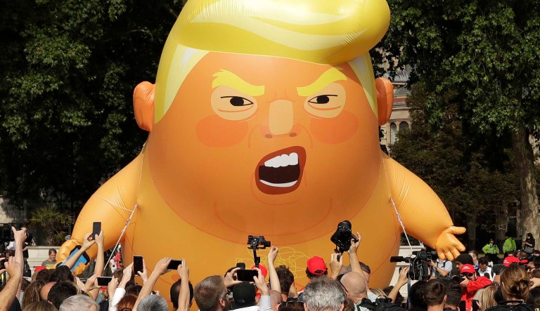 A six-meter high cartoon baby blimp of U.S. President Donald Trump is flown as a protest against his visit, in Parliament Square in London, England, Friday, July 13, 2018. Trump is making his first trip to Britain as president after a tense summit with NATO leaders in Brussels and on the heels of ruptures in British Prime Minister Theresa May's government because of the crisis over Britain's exit from the European Union.