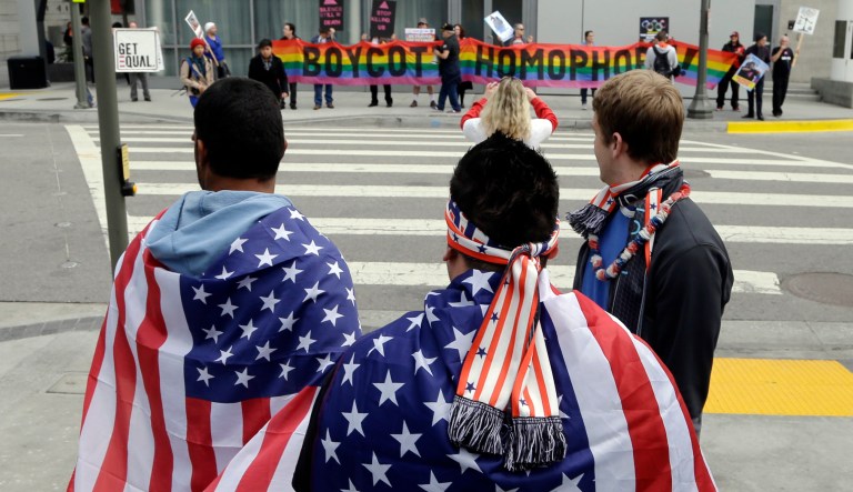 Demonstrators from a coalition of gay rights organizations, religious and political groups protest the treatment of gays in Russia, whose coastal city of Sochi hosts the 22nd Olympic Winter Games, outside the final stop of the "Road to Sochi," a traveling exhibit hosted by the U.S. Olympic Committee, at LALive in downtown Los Angeles Friday, Feb. 7, 2014. 