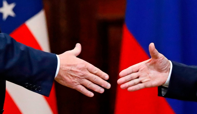 President Trump shakes hand with Russian President Vladimir Putin at the end of the press conference after their meeting at the Presidential Palace in Helsinki, Finland, Monday, July 16, 2018.