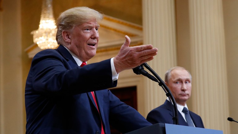 President Trump gestures while speaking as Russian President Vladimir Putin looks on during their joint news conference at the Presidential Palace in Helsinki, Finland on July 16, 2018.