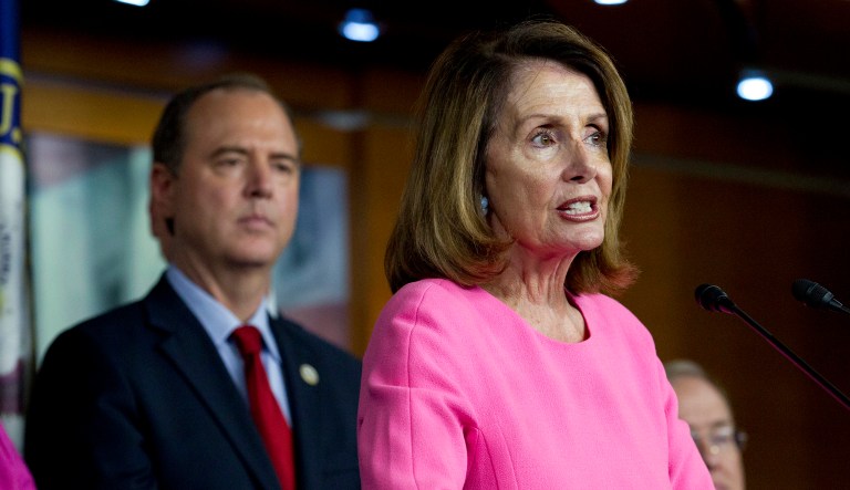 House Minority Leader Nancy Pelosi, D-Calif., accompanied by Rep. Adam Schiff, D-Calif., speaks during a news conference on Capitol Hill in Washington on Tuesday, July 17, 2018.