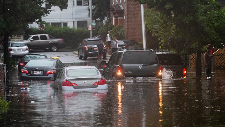 Vehicles are stranded on a Worcester, Mass., street during flash flooding from storms.