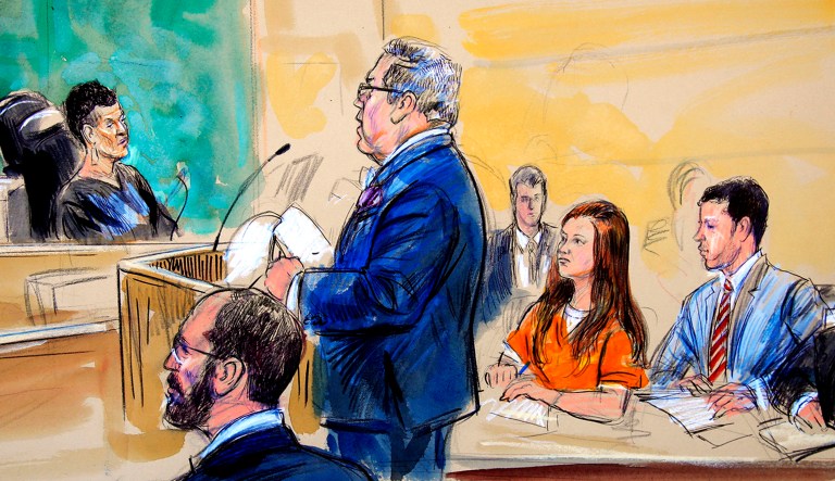 This courtroom sketch depicts Maria Butina, in orange suit, a 29-year-old gun-rights activist suspected of being a covert Russian agent, listening to her attorney Robert Driscoll, standing, as he speaks to Judge Deborah Robinson, left, during a hearing in federal court in Washington.