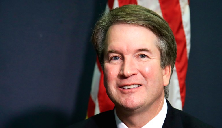 Supreme Court nominee Brett Kavanaugh glances at reporters during a meeting with Sen. James Lankford, R-Okla., on Capitol Hill in Washington.