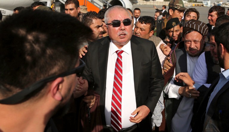Afghan first vice president, a former Uzbek warlord, Gen. Abdul Rashid Dostum, center, and members of his entourage arrive at Kabul International Airport in Kabul, Afghanistan, Sunday, July 22, 2018.
