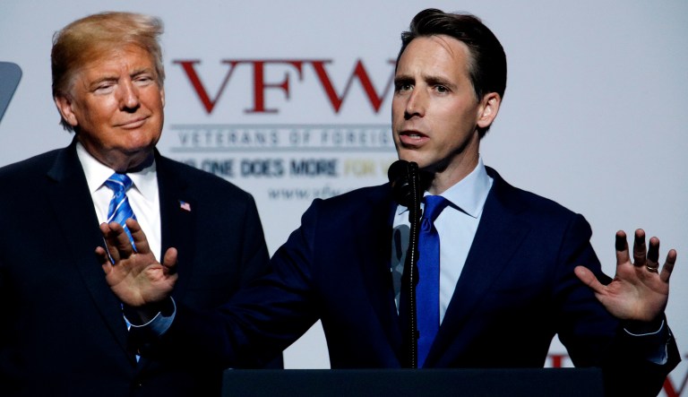Missouri Attorney General and Republican Senate candidate Josh Hawley talks while President Trump listens during an appearance at the Veterans of Foreign Wars national convention on July 24, 2018, in Kansas City, Mo.