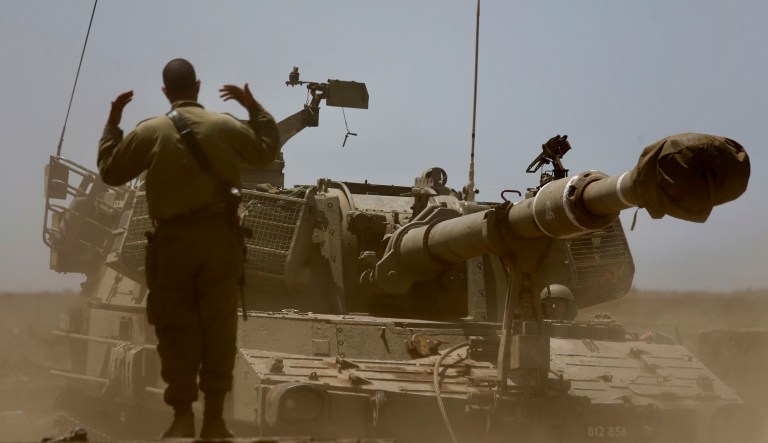 Israeli soldier guides a mobile artillery piece the near the border with Syria in the Israeli-controlled Golan Heights, Wednesday, July 25, 2018.