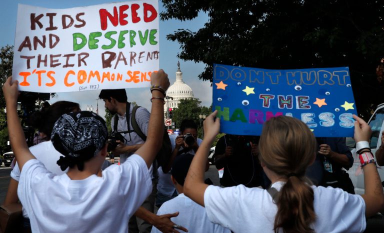 Families march past the U.S. Capitol as they protest the separation of immigrant families, Thursday, July 26, 2018, on Capitol Hill in Washington. 