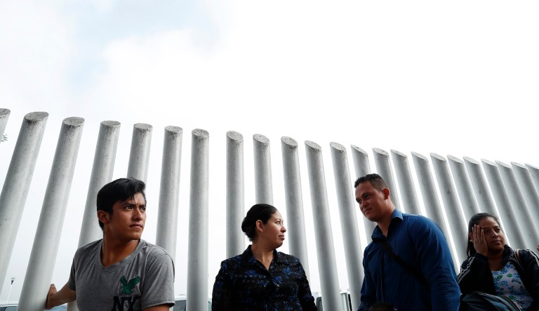 People form a line to cross into the U.S. to begin the process of applying for asylum Thursday, July 26, 2018, near the San Ysidro port of entry in Tijuana, Mexico.