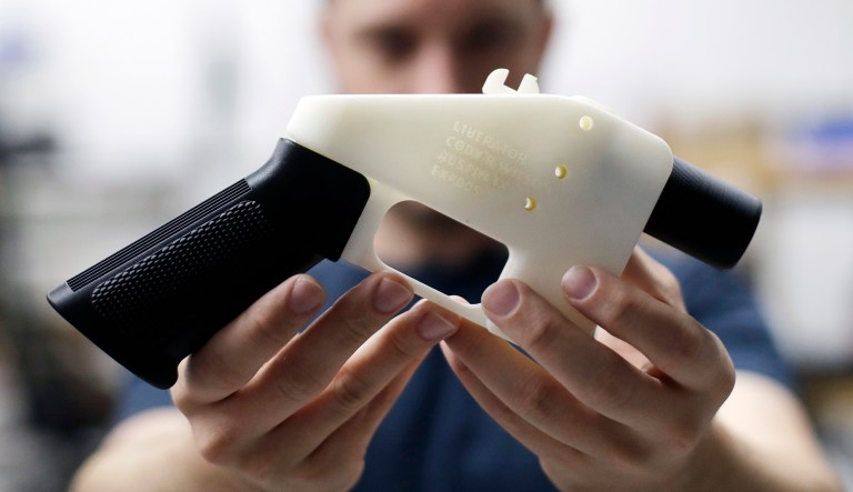 Cody Wilson, with Defense Distributed, holds a 3D-printed gun called the Liberator at his shop on Aug. 1, 2018, in Austin, Texas.
