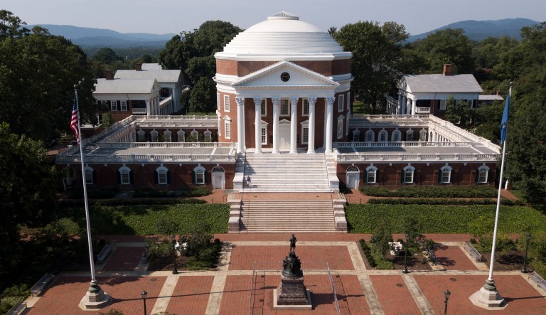 A statue of Thomas Jefferson is surrounded by fencing and a No Trespassing sign in front of the rotunda on the campus of the University of Virginia in Charlottesville, Va.