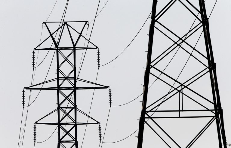 In this photo taken Tuesday, Aug. 14, 2018 power transmission lines deliver electricity along the Interstates 40 and I-85 corridor in Orange County near Hillsborough, N.C. 
