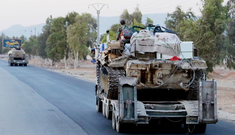 Syrian military move along a road near the village of Almajdiyeh, Syria, on Aug. 14, 2018.