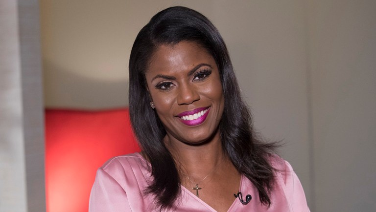 Television personality and former White House staffer Omarosa Manigault Newman smiles during an interview with The Associated Press.