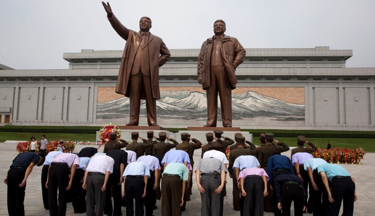 In this Wednesday, Aug. 15, 2018, photo, North Korean soldiers salute as others bow before the giant bronze statues of late North Korean leaders Kim Il Sung and his son Kim Jong Il during the anniversary of the end of World War II and liberation from Japanese colonial rule in Pyongyang, North Korea. North Korea has marked the anniversary with a series of ceremonies ahead of what is expected to be a much bigger event next month, the 70th anniversary of its national foundation day. 