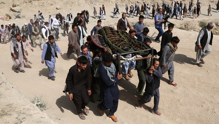 Men carry the coffin of a relative who died in a deadly suicide bombing that targeted a training class in a private building in the Shiite neighborhood of Dasht-i Barcha, in western Kabul, Afghanistan.