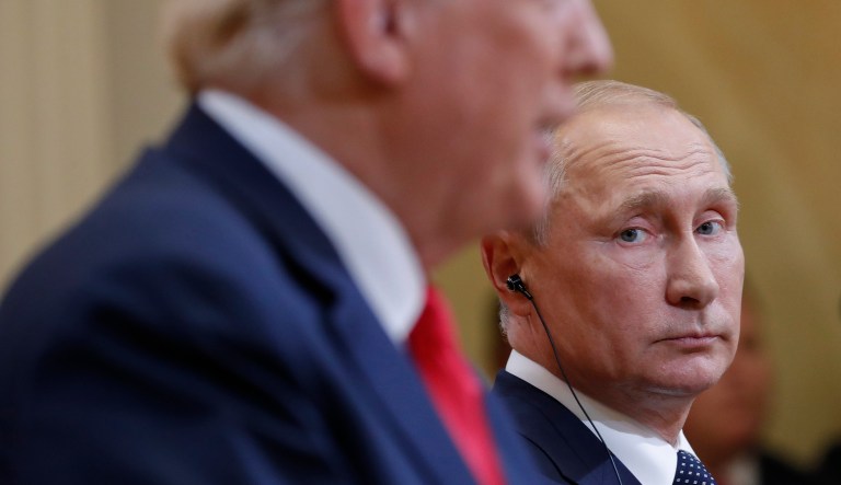 In this July 16, 2018 file photo Russian President Vladimir Putin, right, looks over towards U.S. President Donald Trump, left, as Trump speaks during their joint news conference at the Presidential Palace in Helsinki, Finland.