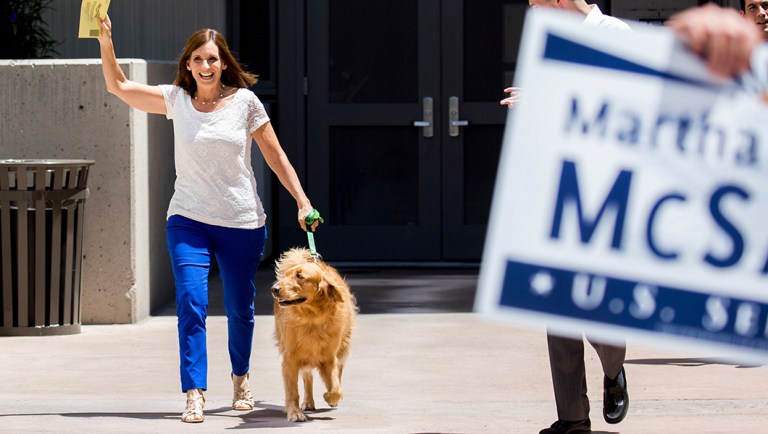 Arizona Rep. Martha McSally, a Republican candidate for Senate, along with dog "Boomer," arrives to drop her ballot off at the Pima County Recorder's Office.