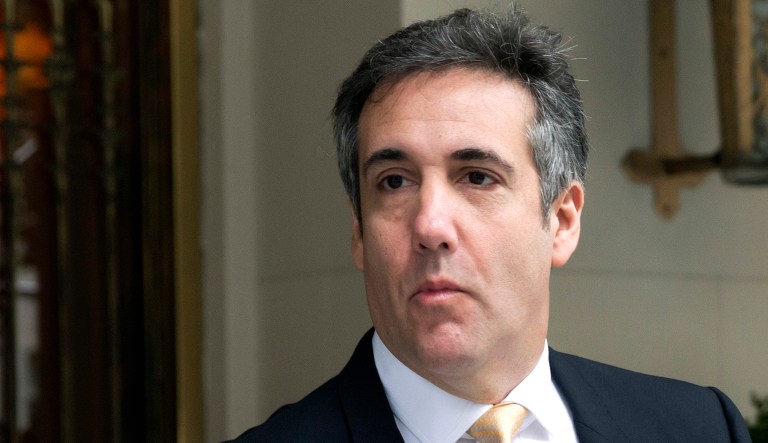 Michael Cohen walks out of a building.