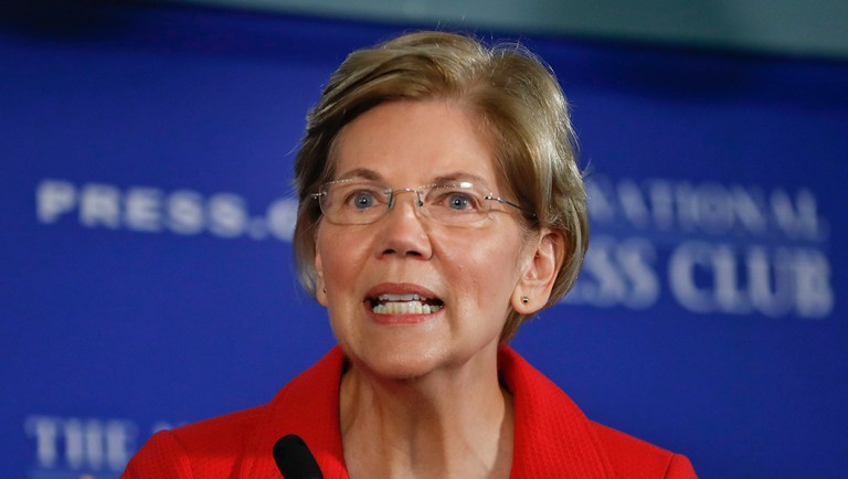 Sen. Elizabeth Warren, D-Mass., gestures while speaking at the National Press Club in Washington.