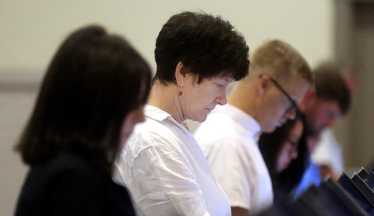 People casts their ballots in a building.